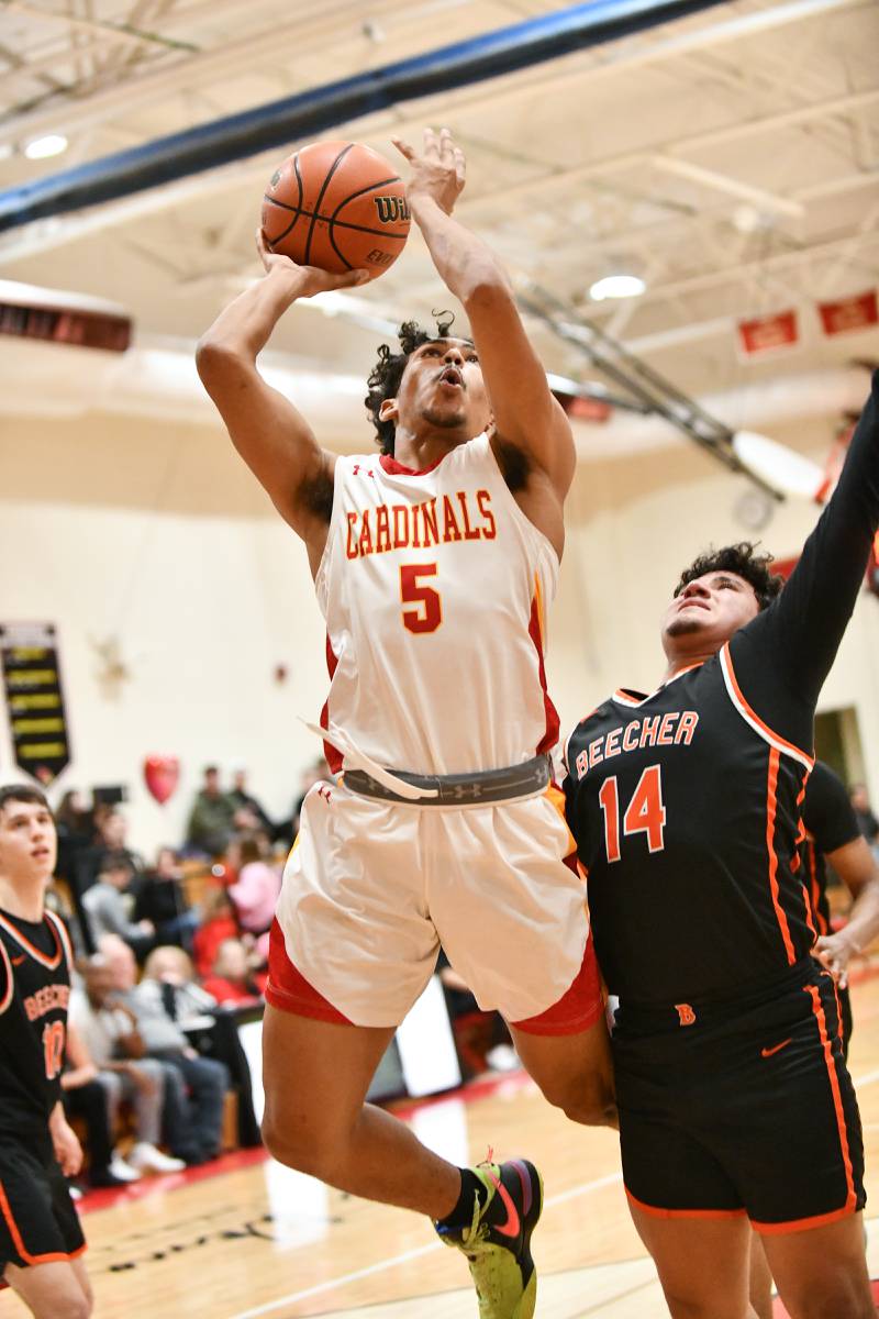 St. Anne's Deion Fifer hits a layup against Beecher's Anthony Moran on Friday, Feb. 14, 2025, during the Cardinals' 70-38 victory over Beecher in the River Valley Conference championship.