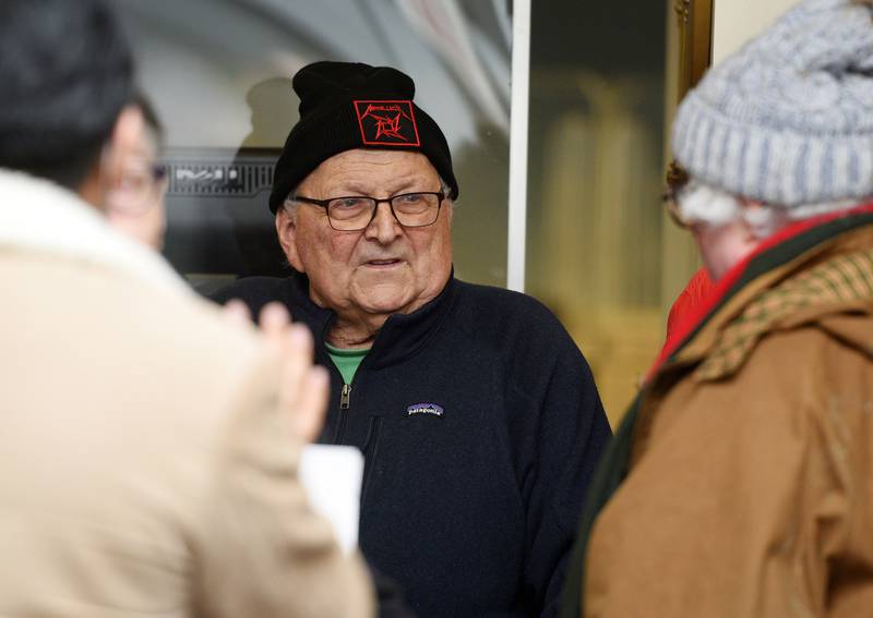 Donning a Metallica cap, Mike Kenyon talks with fellow board member Ken Shepro, right, during the first day of candidate filing at the Kane County Clerk’s office Monday, March 7, 2022 in Geneva.