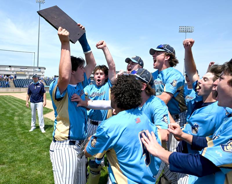 Marquette's Beau Ewers raises the supersectional plague Monday after defeating Newman 12-1 in 5 innings at Rockford Rivets Stadium.