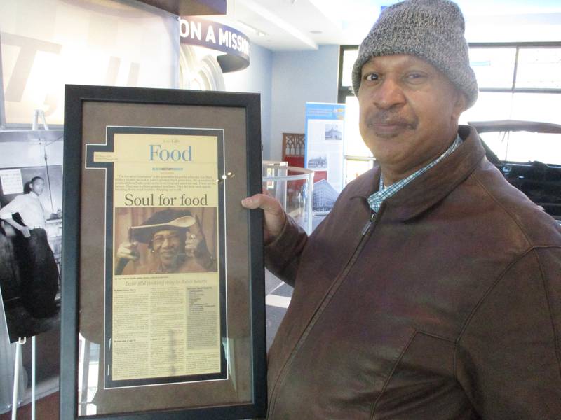 Darren McDaniel holds a framed article from The Herald-News that tells the story of his aunt, Ann Lane, and her reputation as a soul food chef in Joliet. He brought the article to the "History in Our Hands" event at the Joliet Area Historical Museum on Saturday. Feb. 22, 2025