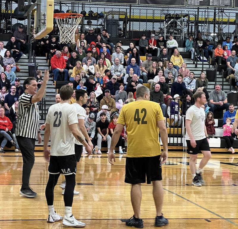 Former Sycamore High School Principal Tim Carlson dolled out a foul during the first annual Heroes on the Hardwood, a charity basketball game between Sycamore Fire and Police officers and Sycamore Community School District staff and faculty on Dec. 19, 2023.