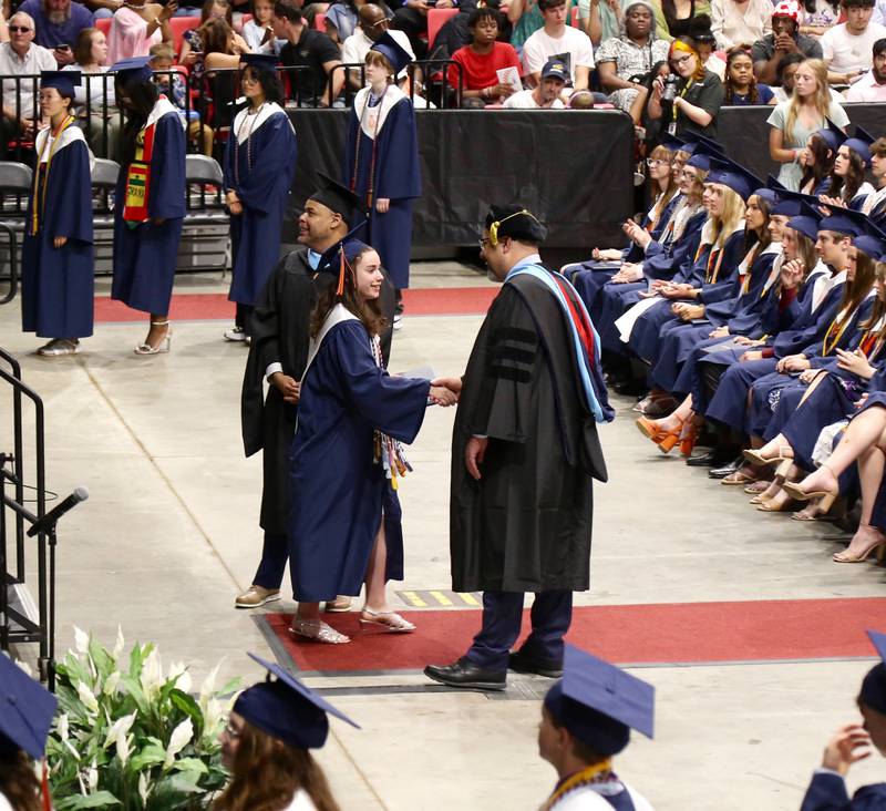 A brand new Oswego High School graduate gets congratulated by Dr. Andalib Khelghati, Superintendent of Schools for District 308 at the Oswego High School Class of 2024 Commencement Ceremony on Saturday, May 18, 2024 in DeKalb.