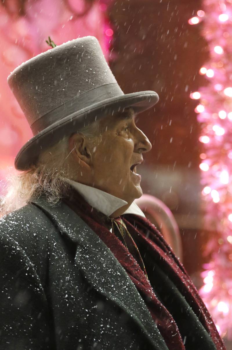 Mike Nowak sings with the Froze Robins during Crystal Lake's Luminary Nights on Thursday, Dec. 19, 2024, in downtown Crystal Lake. The snowy night featured sidewalks lite luminaries, holiday shopping and a visit to the Santa House.