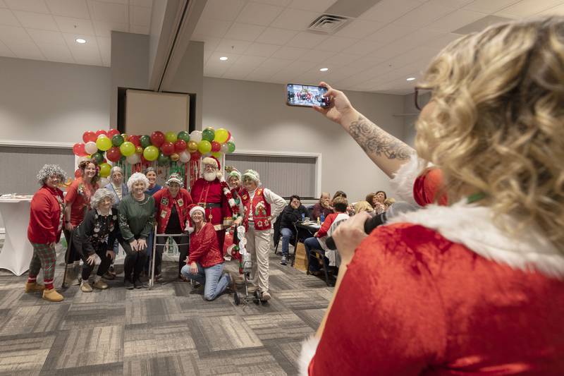 The Bingo grannies have their picture taken after winning the Hometown Holidays Bingo Christmas costume contest Thursday, Nov. 20, 2025, in Rock Falls.