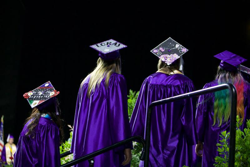 Students line up to receive their diplomas during the Hampshire High School graduation ceremony on May 21, 2022, at the NOW Arena in Hoffman Estates.