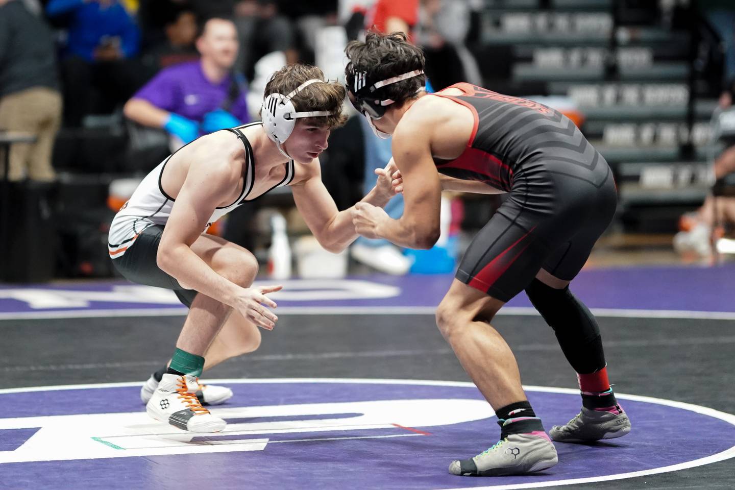 Kaneland’s Alex Gochis circles the mat against East Aurora’s Josh Delgado during their 138 pound championship bout in the Plano Reaper Classic Wrestling meet at Plano High School on Saturday, Dec. 14, 2024.