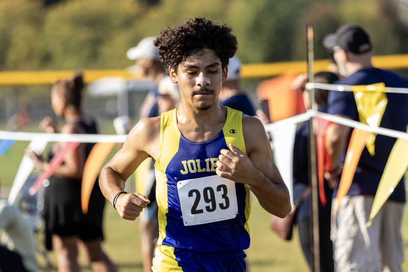 Joliet Central’s Erick Ortiz crosses the finish line at the Locktoberfest three-mile varsity cross country race at Dellwood Park in Lockport on October. 4, 2025.
