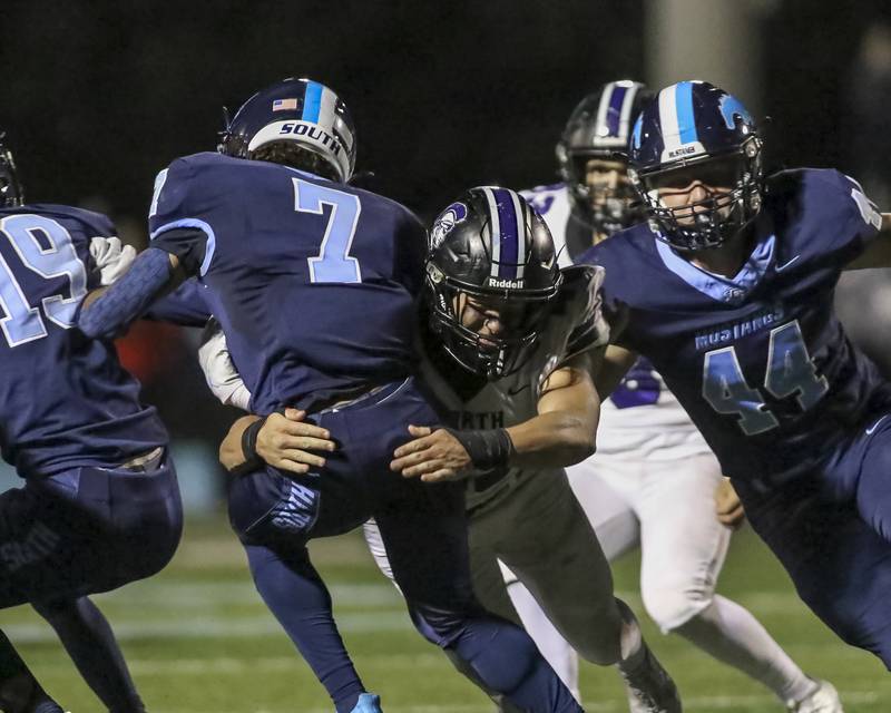 Downers Grove North's Rhys Dominow (45) tackles Downers Grove South's Antoine Hardin (7) during football game between Downers Grove North at Downers Grove South Friday, Sept 5, 2025  in Downers Grove.