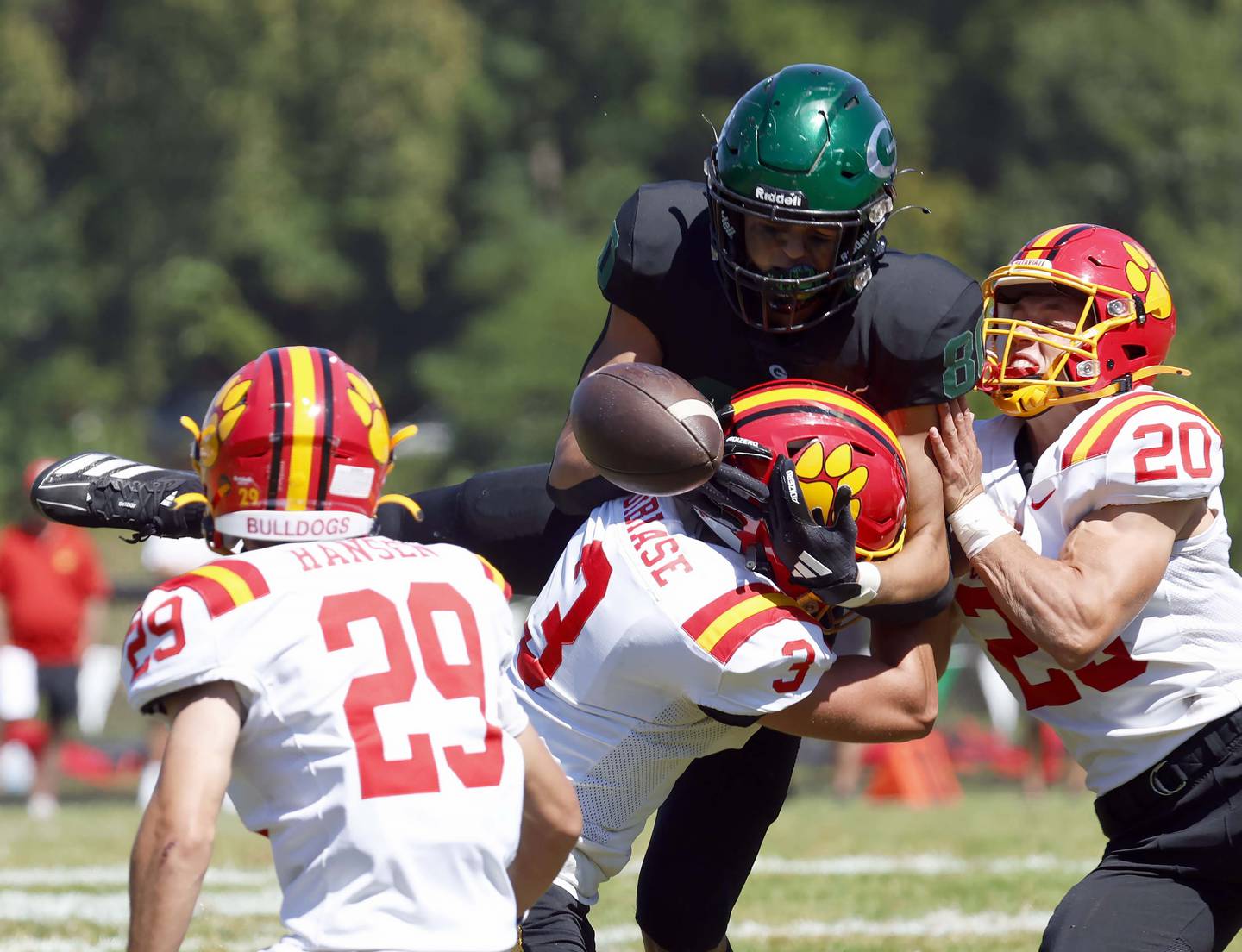 Glenbard West's Brady Johnson (80) tries in vain to pull in a long pass as Batavia's Matt Hansen (29) Drew DiBiase (3) and Chase Osborne (20) pressure him Saturday, Aug. 31, 2024 at Duchon Field in Glen Ellyn. The pass fell incomplete.