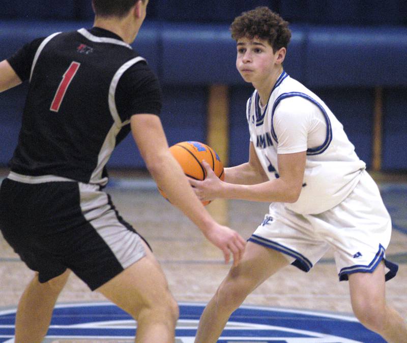 Newman's Easton Coward  passes around Erie-Prophetstown's Keegan Winckler.  The Newman Comets hosted the Erie-Prophetstown Panthers in a Conference game. played at Newman High School on February 6, 2026.