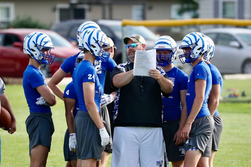 PHS coach Ryan Pearson goes over plays with the Tigers during Monday's 7 on 7 games with Bureau Valley and Annawan-Wethersfield at Little Siberia.