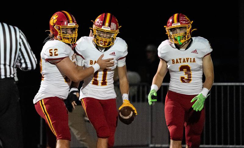 Batavia’s Gerke Drew (11) is greeted by Jack David (52) and Ryan Whitwell (3) after scoring a touchdown against Glenbard North during a football game at Glenbard North High School in Carol Stream on Friday, Sep 23, 2022.