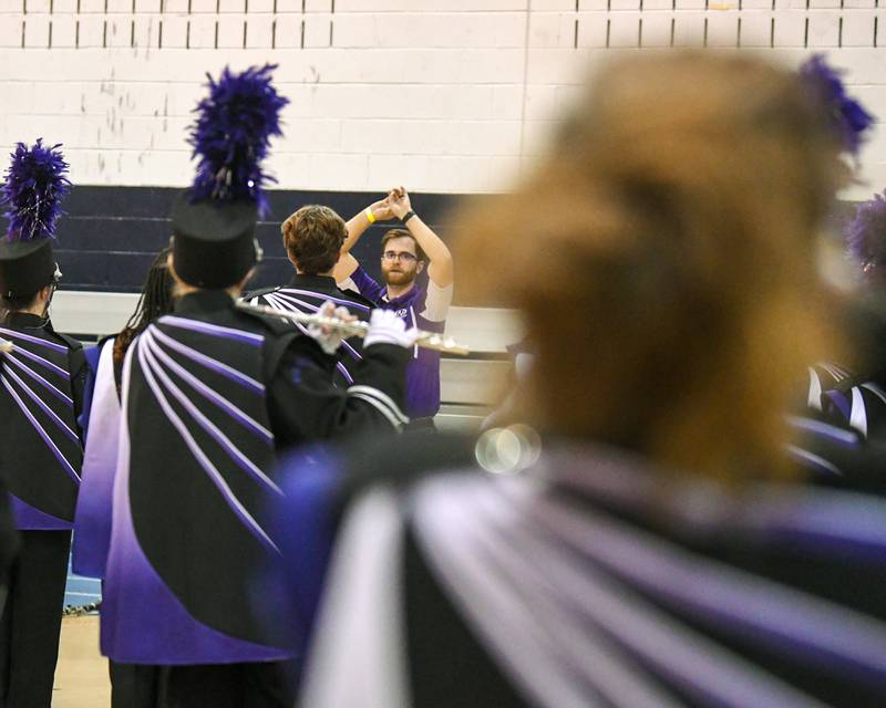 Downers Grove North Band director Jessen T. Smith warms up the Downers Grove North band before they take the field at the Downers Grove South Marching Mustangs Music Bowl on Saturday Oct. 5, 2024, held at Downers Groves South football field.