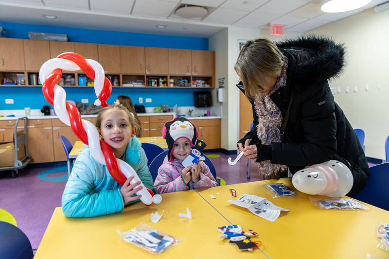 Lockport residents Raelynn and Paige Schumann make holiday crafts with a little help from Mary Zeman inside the White Oak Library District’s Lockport Branch during Lockport’s Christmas in the Square festivities on Nov. 29, 2025.