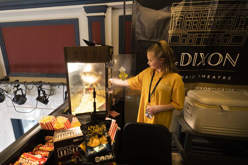 Nora Highlye, 10, dumps a pot of popcorn Sunday, March 2, 2025, as the reopening of The Dixon takes shape.