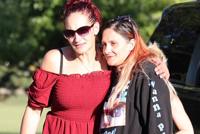 Ericka Sasso, (left) mother of Gracie Sasso-Cleveland, gets a hug from her friend Tiffany Ladson, of DeKalb, Thursday, Sept. 14, 2023, at the Sycamore Community Sports Complex during a celebration of the life of Gracie on what would have been her sweet 16 birthday. Sasso-Cleveland, 15, was found dead May 7, 2023, in DeKalb. Timothy M. Doll, 29, of DeKalb, is charged with first-degree murder in her death.