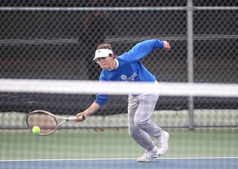 Marta Fito of Woodstock High School reaches for the ball during the first day of the IHSA state tennis tournament at Rolling Meadows High School on Thursday, Oct. 20, 2022.