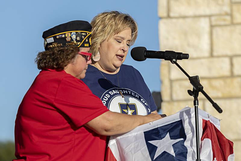 Melanie Konecny and Kendra Hull read names of servicemen from Lee and Whiteside County who are on the Vietnam Traveling Memorial Wall during the opening ceremony Friday, Sept. 1, 2023 in Rock Falls.