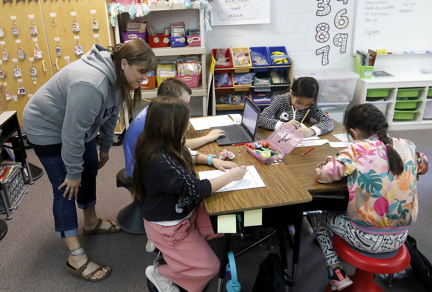 Zoki Russo, a third grade teacher at Sleepy Hollow Elementary School, works with students as she teaches her class.