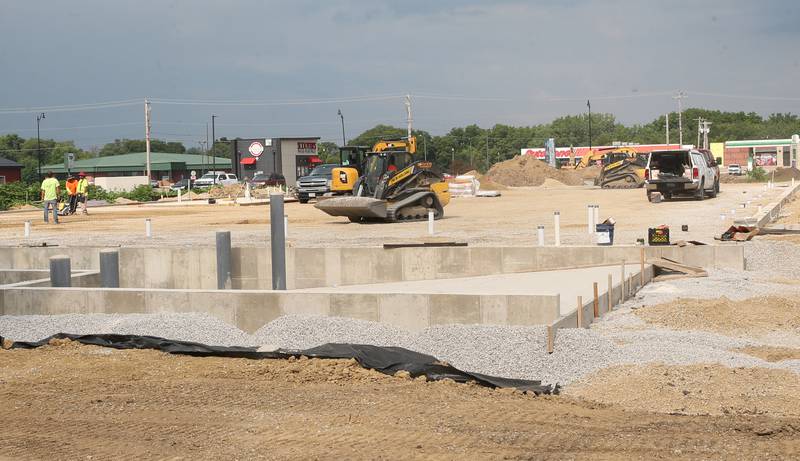 Crews move dirt near the intersection of Backbone Road and North Main Street on Tuesday, July 8, 2025 in Princeton. The foundation of a future Aldi store can be seen in the distance. Work begain on the property beginning in April this year.
