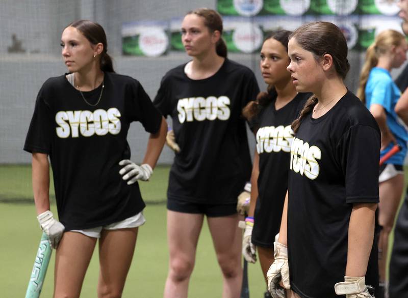 Sycamore Sycos softball players wait for their turn in the batting cage Wednesday, June 18, 2025, at their indoor practice facility in DeKalb.