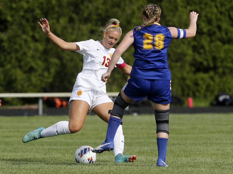 Richmond-Burton's Jordan Otto kicks the ball away from Johnsburg's Mackenzie McQuiston during the IHSA Class 1A Marian Central Sectional Championship match on Tuesday, May 21, 2024, at Marian Central High School.