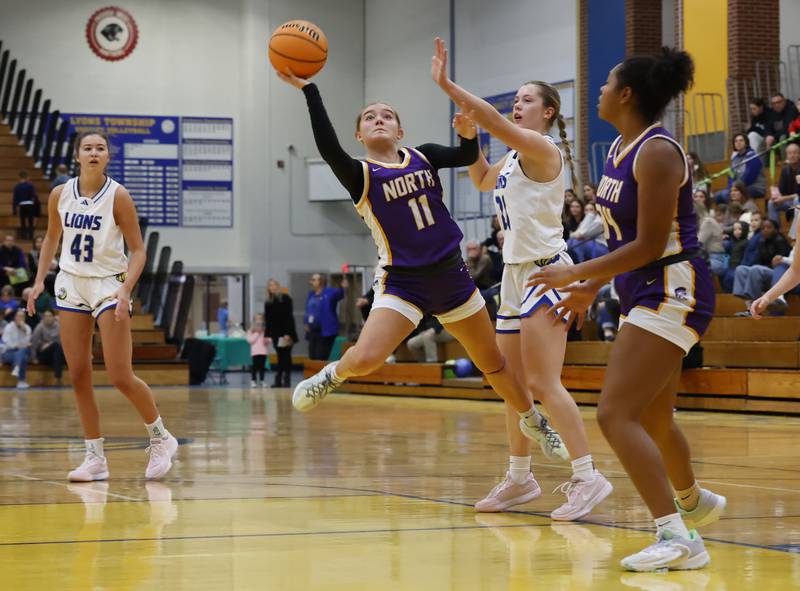 Downers Grove North's Abigail Gross (11) puts up a shot during the girls varsity basketball game between Downers Grove North and Lyons Township on Saturday, Jan. 11, 2025 in La Grange.