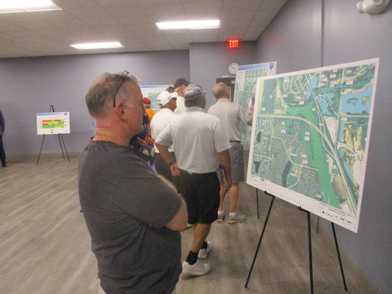 Plainfield resident Kevin Calkins checks out an exhibit on display during the Illinois Department of Transporation's public hearing in Romeoville on Wednesday for proposed interchanges at Lockport Street/Airport Road and Route 126 in Will County. Sept. 25, 2024