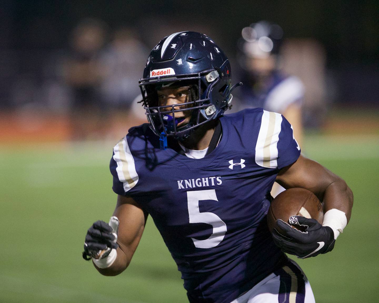 IC Catholic's Aaron Harvey runs the ball for a gain against Nazareth on Friday, Sept.15,2023 in Elmhurst.