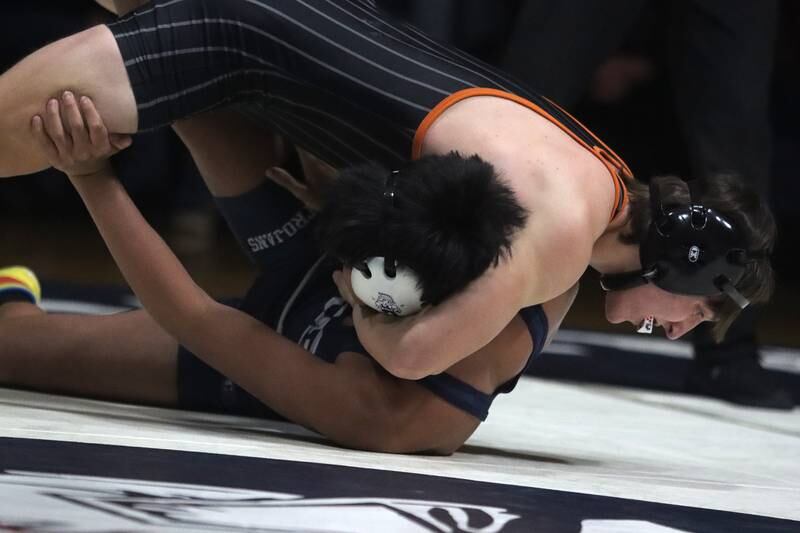 Crystal Lake Central’s Dominic Vitale, top, battles Cary-Grove’s Jaden Olivares at 157 pounds in varsity wrestling Thursday, Dec. 19, 2024 at Cary-Grove High School in Cary.