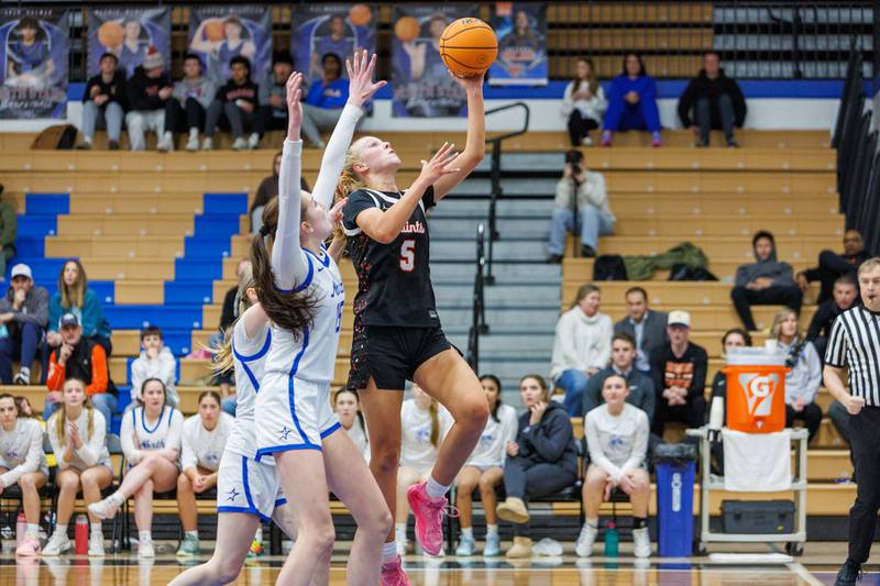 St. Charles East's Brooklyn Schilb  goes in for the layup against St. Charles North on Jan. 30, 2026 in St. Charles.