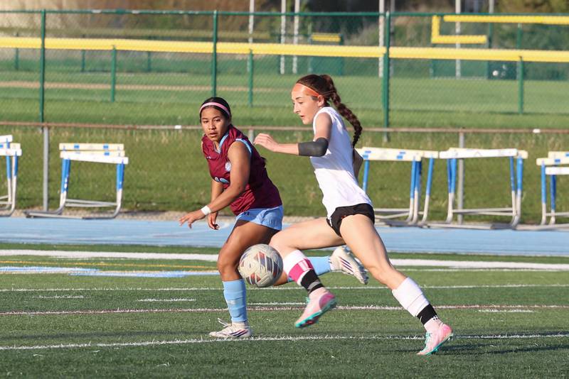 Beecher's Grace Durante controls the ball en route to scoring a goal as Kankakee's Rachel Sanchez-Aguilar defends during Kankakee's 8-4 victory over Beecher on Wednesday, April 22, 2026.