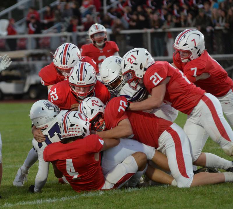 Oregon defenders pile on a Rockford Lutheran running back on Friday, Sept. 5, 2025 at Landers-Loomis Field in Oregon. The Hawks lead 40-0 at the half and went on to win 40-8 to boost their record to 2-0.