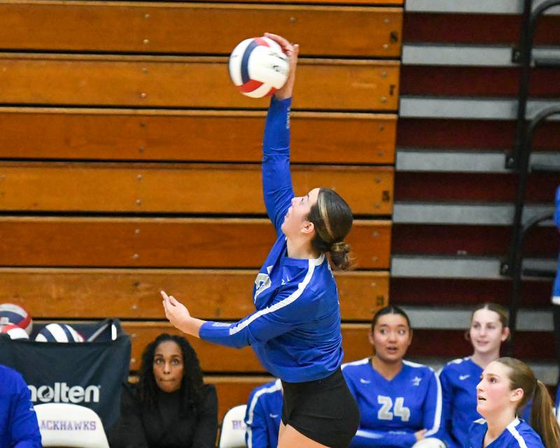 St. Charles North's Haley Burgdorf (23) spikes the ball over the net during the first of two games on Thursday Nov. 7, 2024, while taking on Benet Academy during th 4A sectional championship game held at West Aurora High School.