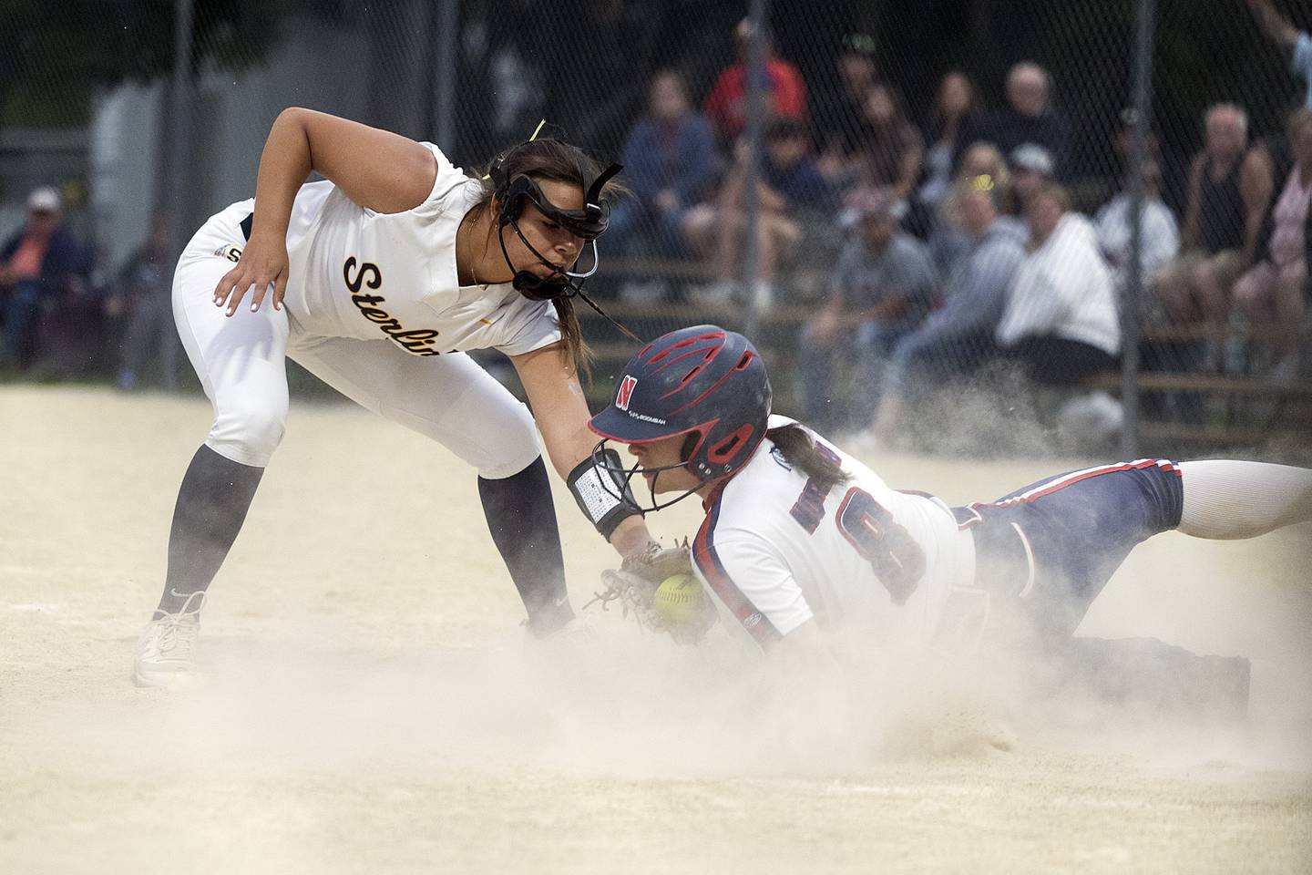 Sterling’s Layla Wright tags out Belvidere North’s Alexa Norgard Friday, May 30, 2025, in the Class 3A Regional final in Dixon.