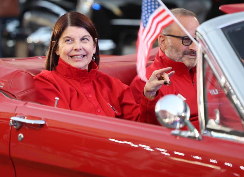 Northern Illinois University president Lisa Freeman greets onlookers as she rides through downtown DeKalb Thursday, Oct. 17, 2024, during the parade at the Huskie Homecoming Block Party.