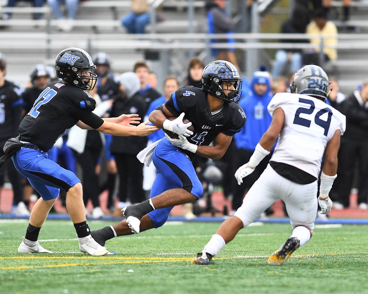 Lincoln-Way East's Trey Johnson (4) attempting to run for big gain against Oswego East on Saturday, Oct. 30, 2021, at Lincoln-Way East High School in Frankfort.