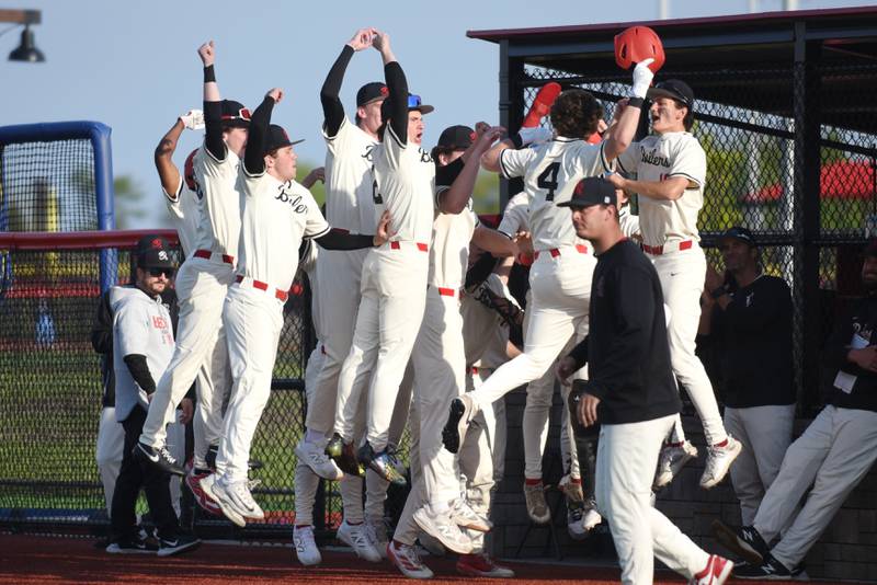 Members of the Bradley-Bourbonnais baseball team greet Eric Rainbolt (4) in the dugout following his home run during a home game against Stagg Friday, May 8, 2026.