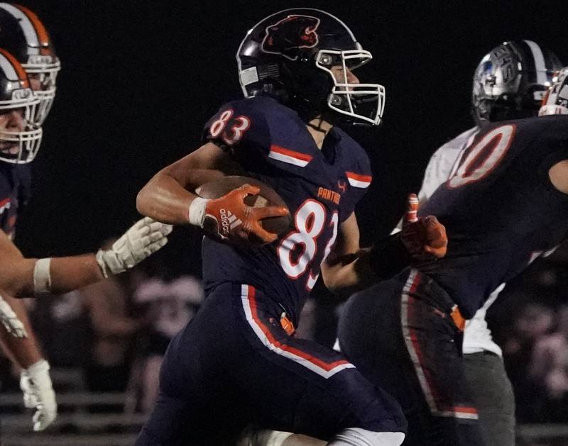 Oswego’s Teddy (theodore) Manikas (83) carries the ball on a sweep against Oswego East during a football game at Oswego High School on Friday, Oct. 20, 2023.