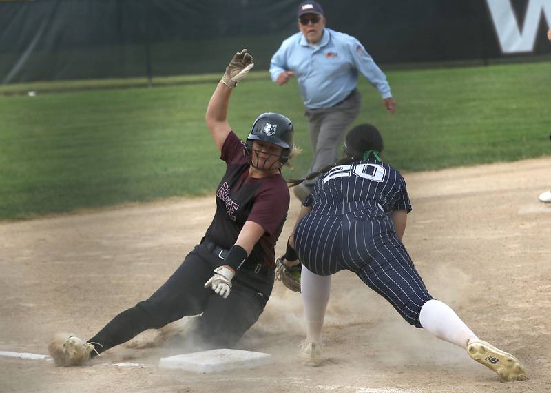Prairie Ridge's Bella Moore slides into third base as Cary-Grove’s Addison DeSomer tries to apply the tag during the Class 3A Prairie Ridge Regional Championship softball game on Friday, May 22, 2026, at Prairie Ridge High School.