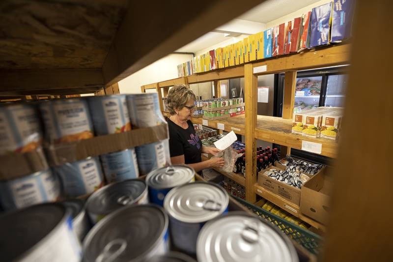 Dana Grace of Dixon looks over a list Wednesday, Oct. 29, 2025, while gathering food items at the Community Food Pantry. Pantries all over the area are expecting an increase in need with the suspension of Snap benefits.