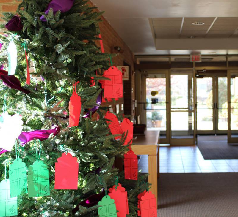 The St. Patrick Parish Giving Tree is a Christmas tree placed in the lobby of the church, filled with tags as ornaments.