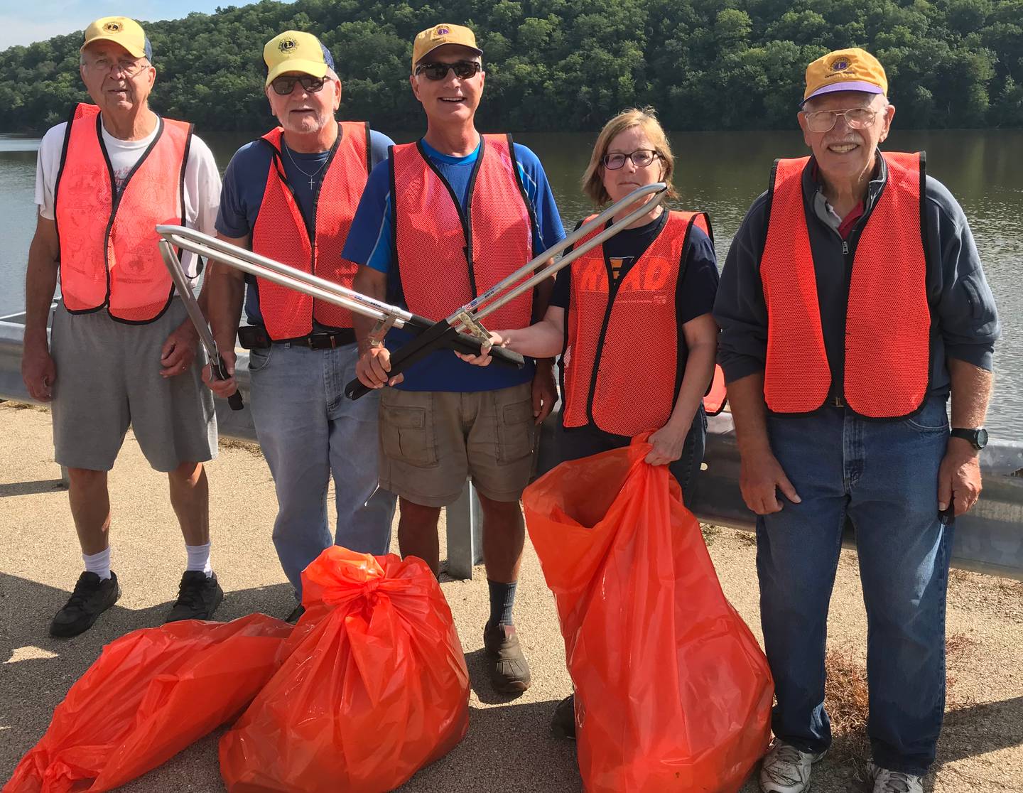 (Left to right); Oregon Lions Club members Jerry Hinrichs, Ed Smola, Grant Afflerbaugh, Lori Peterson, and Ray Farrey cleaning up garbage off of Illinois Route 2 Tuesday, Aug. 16, north of Oregon. Not pictured is fellow Lions Club member Jim Hoff.