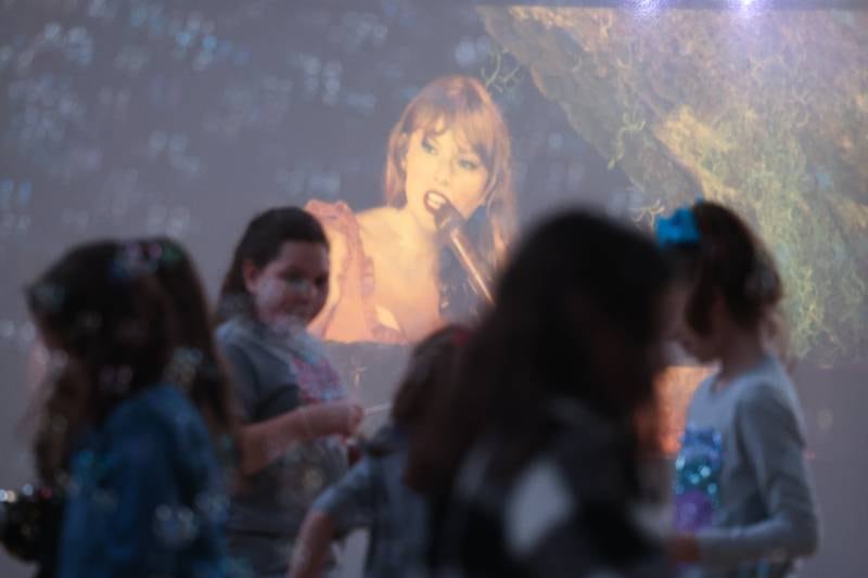 Swifties dance to a Taylor Swift video at the Taylor Swift fan party hosted by the Lockport Township Park District on Saturday, Feb. 10, 2024 in Lockport.