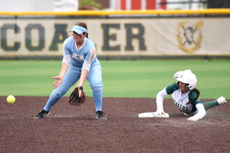 Joliet Catholic's Addy Rizzatto, left, fields a throw at second base as Coal City's Masyn Kuder slides in during the Class 2A Coal City Regional semifinals Wednesday, May 21, 2025.