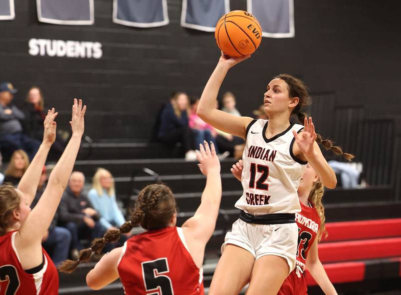 Indian Creek's Isabella Turner shoots over two Aurora Christian players during their game Monday, Nov. 25, 2024, at Indian Creek High School in Shabbona.