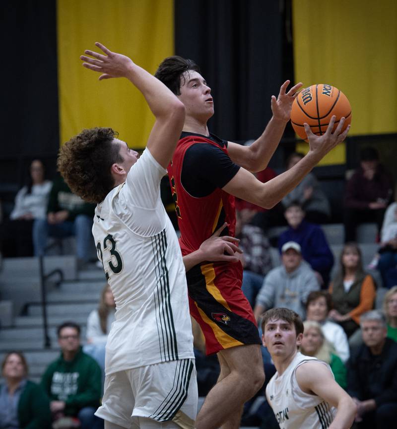 St. Anne's Matthew Langellier elevates for a shot as Bishop McNamara's Karter Krutsinger guards in a game on Wednesday, November 26, 2025.