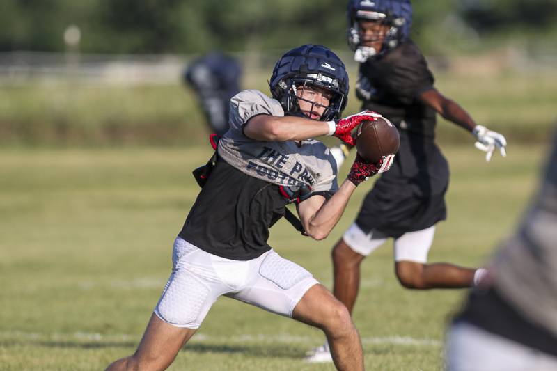 Lincoln Ijams makes a catch up the middle at Oswego East  High School football practice, Monday, Aug 13, 2025 in Oswego.