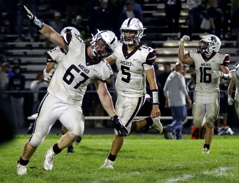 Prairie Ridge's John Fallaw, Joseph Vanderwiel, and Dominic Creatore celebrate their 21-20 win over Cary-Grove in a Fox Valley Conference football game on Friday, Sept. 22, 2023, at Cary-Grove High School in Cary.