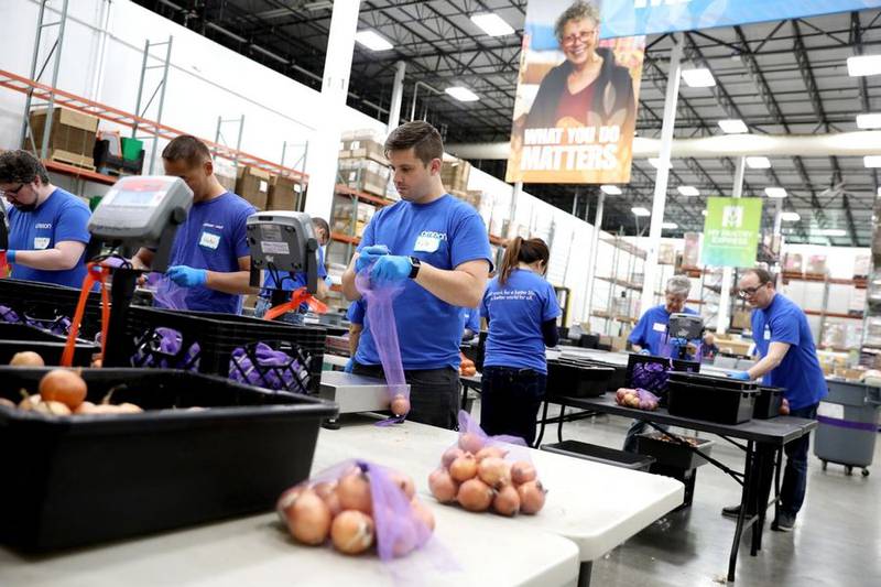 Volunteer Kyle Alberti sorts through bulk onions at the Northern Illinois Food Bank during a day of service May 18 with his employer, Omron Corp., in Geneva.